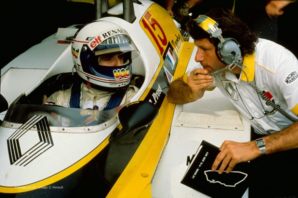 Alain Prost inside of his Renault car speaking with the team principal.
